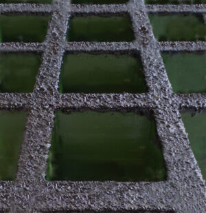 Close up of green GRP grating with a non-conductive coating